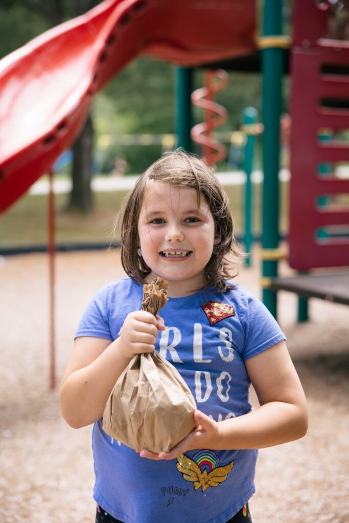 Child holding a sack lunch - SPFB